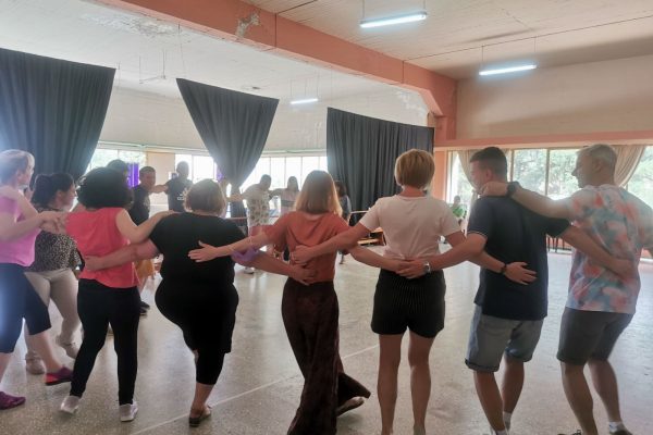 Satff take part in Greek dancing